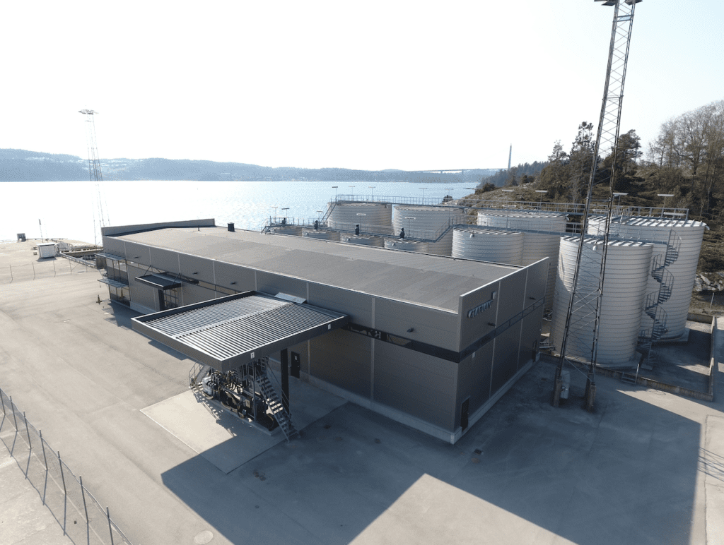 Clariant’s facility in Uddevalla, Sweden; and industrial building with a lake and blue sky behind it