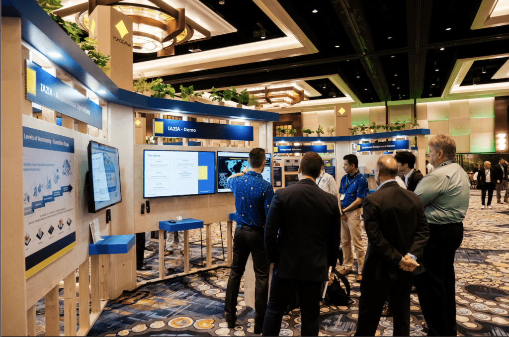 A group of engineers viewing an industrial automation demonstration at an industry conference